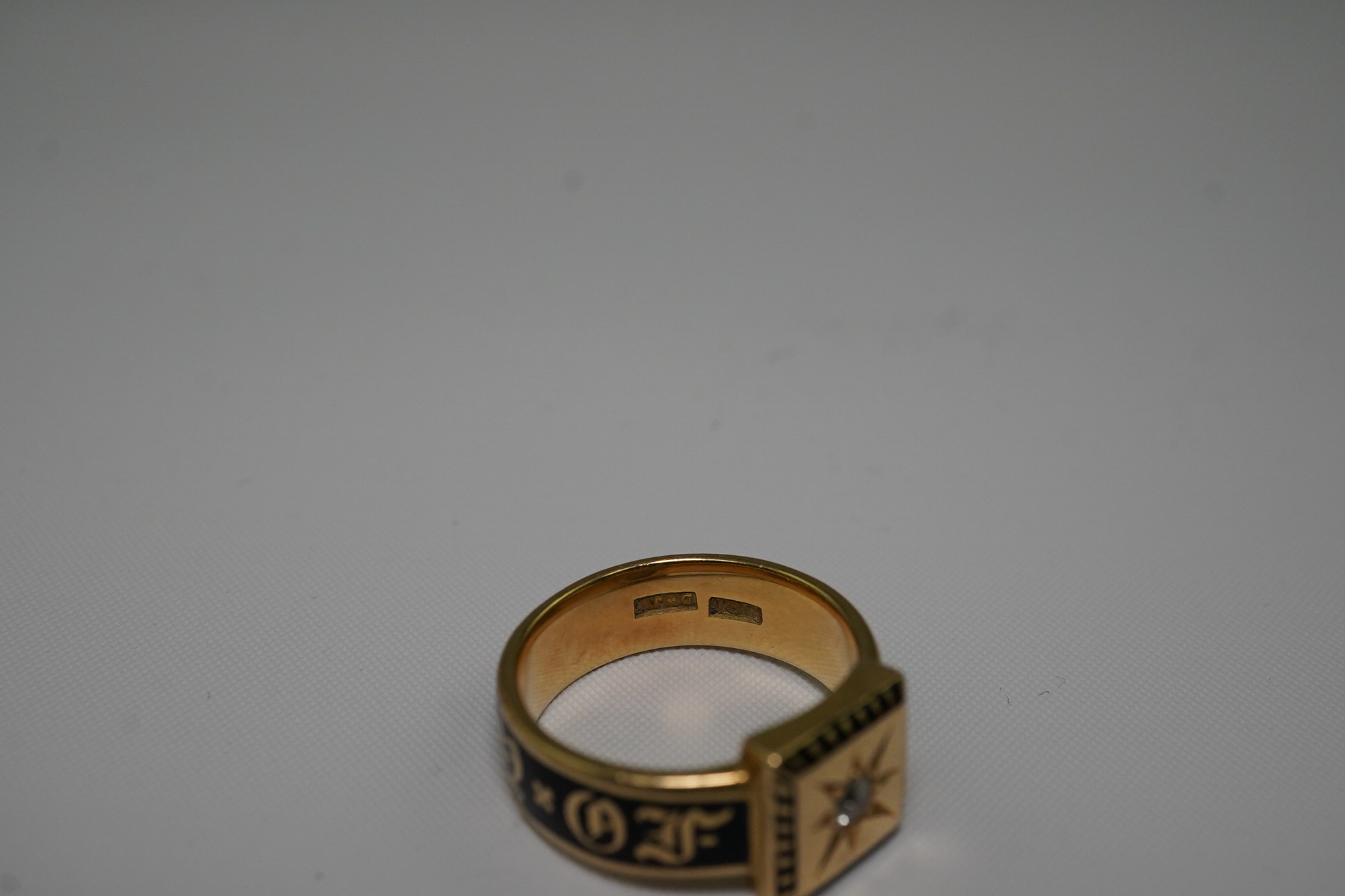 A 19th century 18ct gold, black enamel and single stone diamond set 'In Memory Of' ring